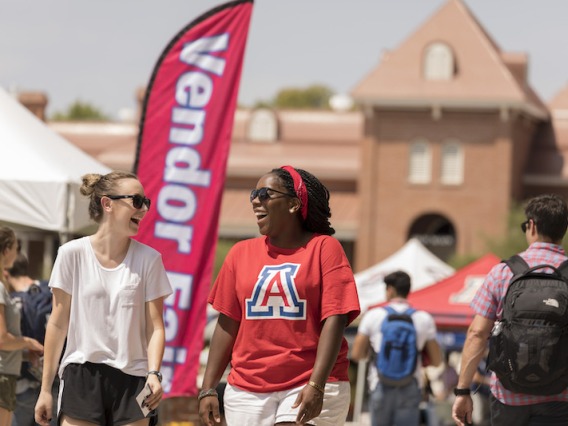 Two students at an event on the University of Arizona mall