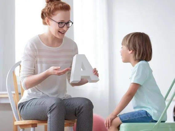 Adult teaching a child the alphabet