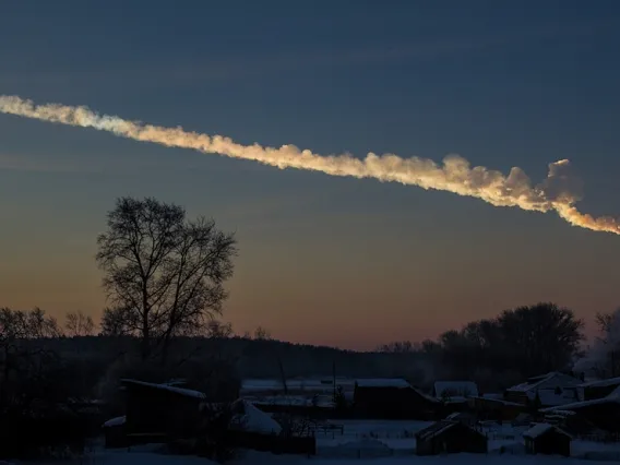 a trail of clouds in the sky created by a meteorite falling to Earth