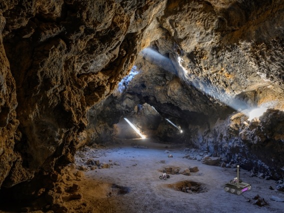 Artist&#039;s impression of rovers exploring a lava tube or cave