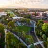 an aerial photo of campus at sunrise with old main as the focal point