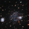 Sculptor A, one of three newly discovered dwarf galaxies - and unrelated to the well-known Sculptor spiral galaxy - is visible here as a faint accumulation of stars beyond several bright stars in the foreground. 